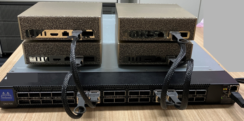 Four NVIDIA DGX Spark units stacked on their own network fabric switch